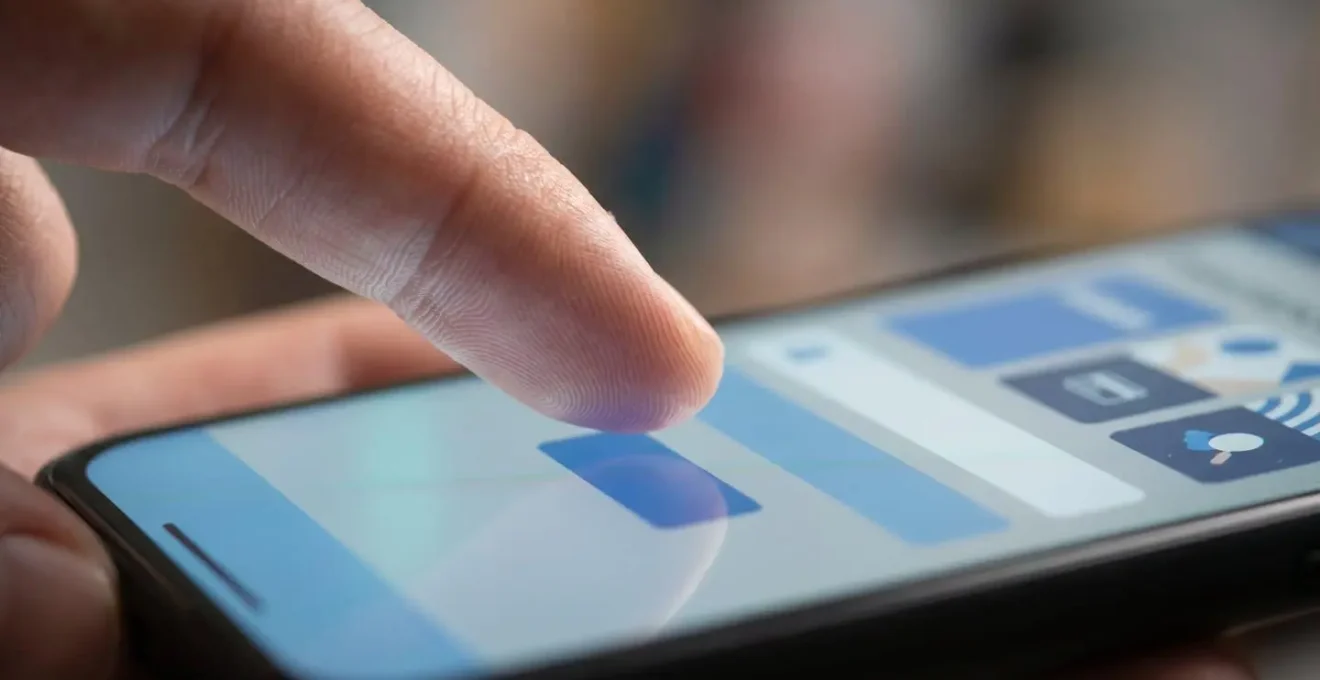 Gros plan sur des mains manipulant un smartphone pour sélectionner les options d'assurance voyage incluant la garantie Covid-19